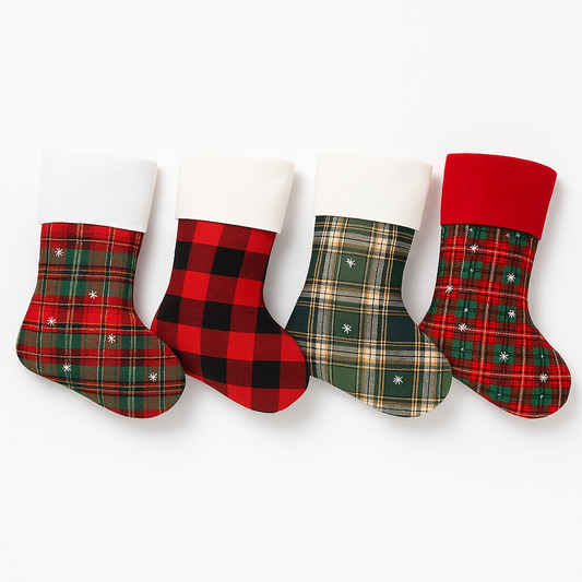 Set of four Christmas stockings with red and green plaid patterns arranged on a white background.